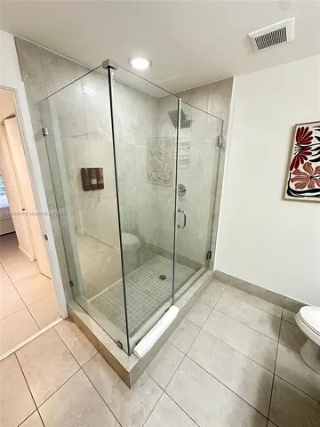 a bathroom with a glass shower door