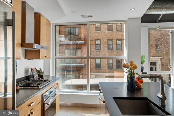 a kitchen with kitchen island a large window in it