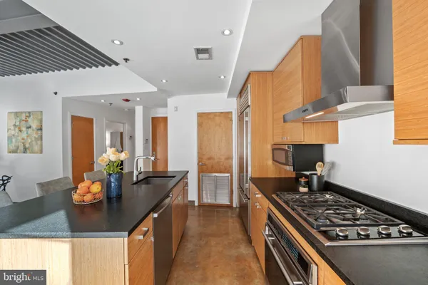 a kitchen with stainless steel appliances granite countertop a stove and a sink