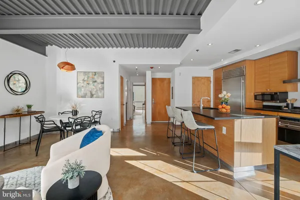 a kitchen with counter top space and living room