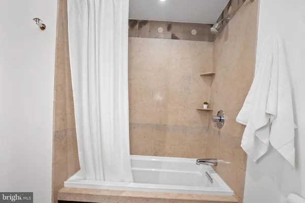 a bathroom with a granite countertop toilet sink and mirror