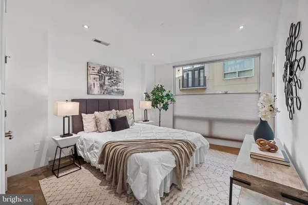 a bedroom with a bed and a couch