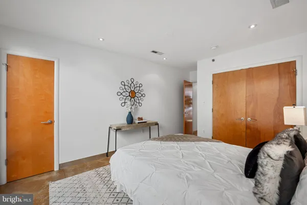 a bedroom with a bed and a potted plant