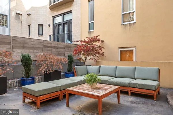 a outdoor space with patio furniture and a fireplace