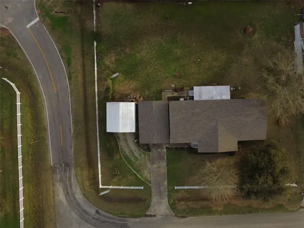 an aerial view of a house with a yard
