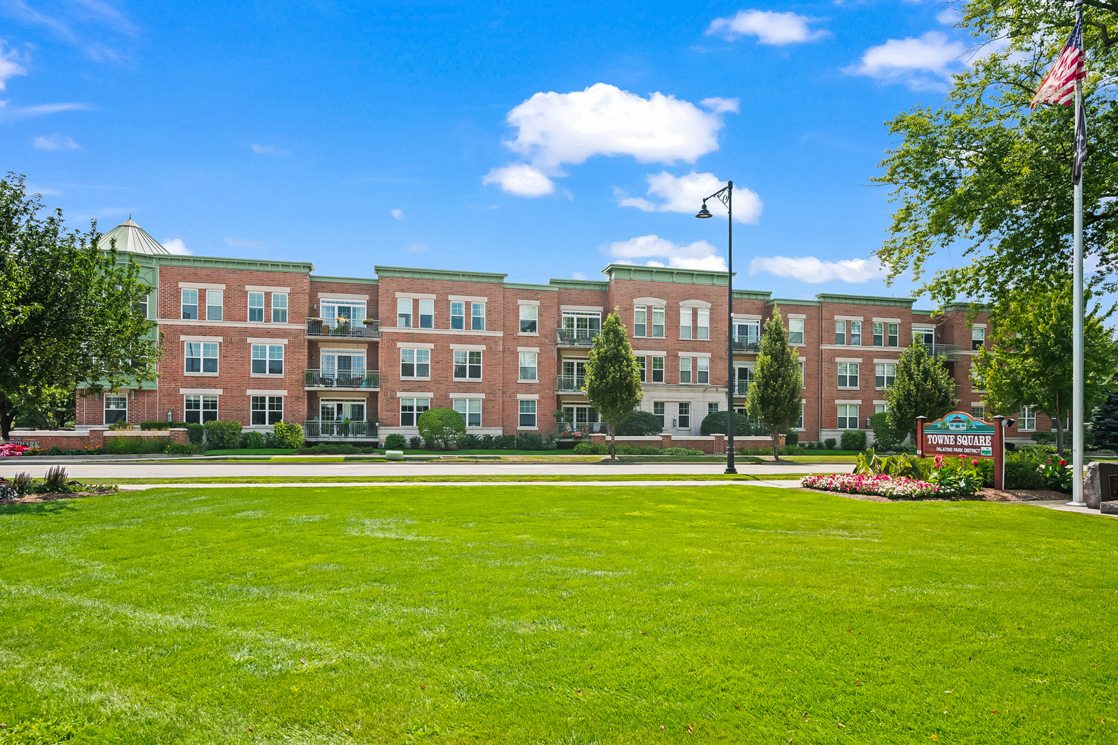a view of a building with a big yard and palm trees