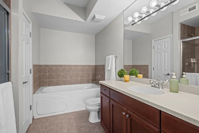 a bathroom with a sink a toilet and bathtub