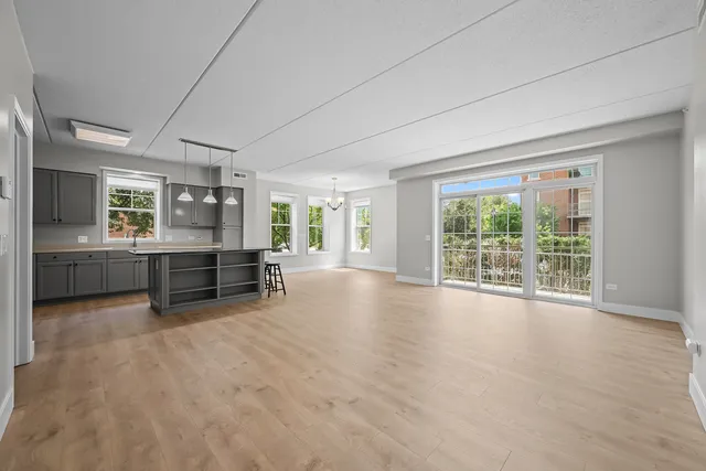 a view of an empty room with windows and cabinet