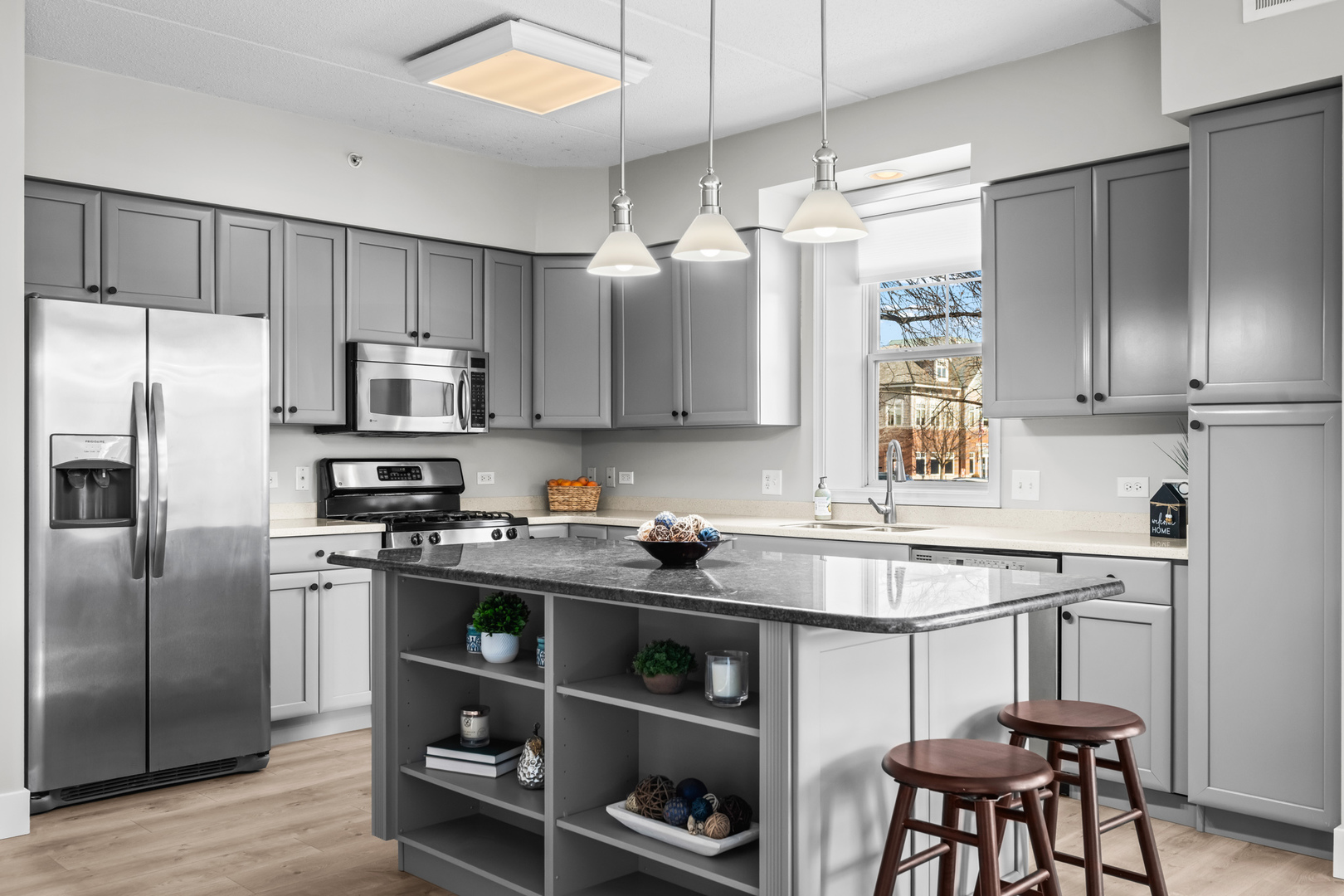 133 West Palatine Road, Unit 107A Palatine, IL 60067 - Photo 5 of 16 a kitchen with stainless steel appliances a sink a stove a refrigerator cabinets and a dining table