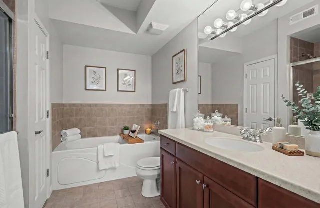 a bathroom with a sink vanity granite and toilet