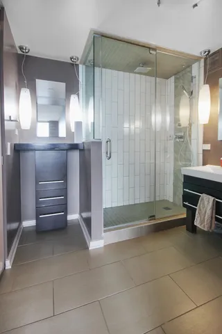 a bathroom with a glass shower door and a sink