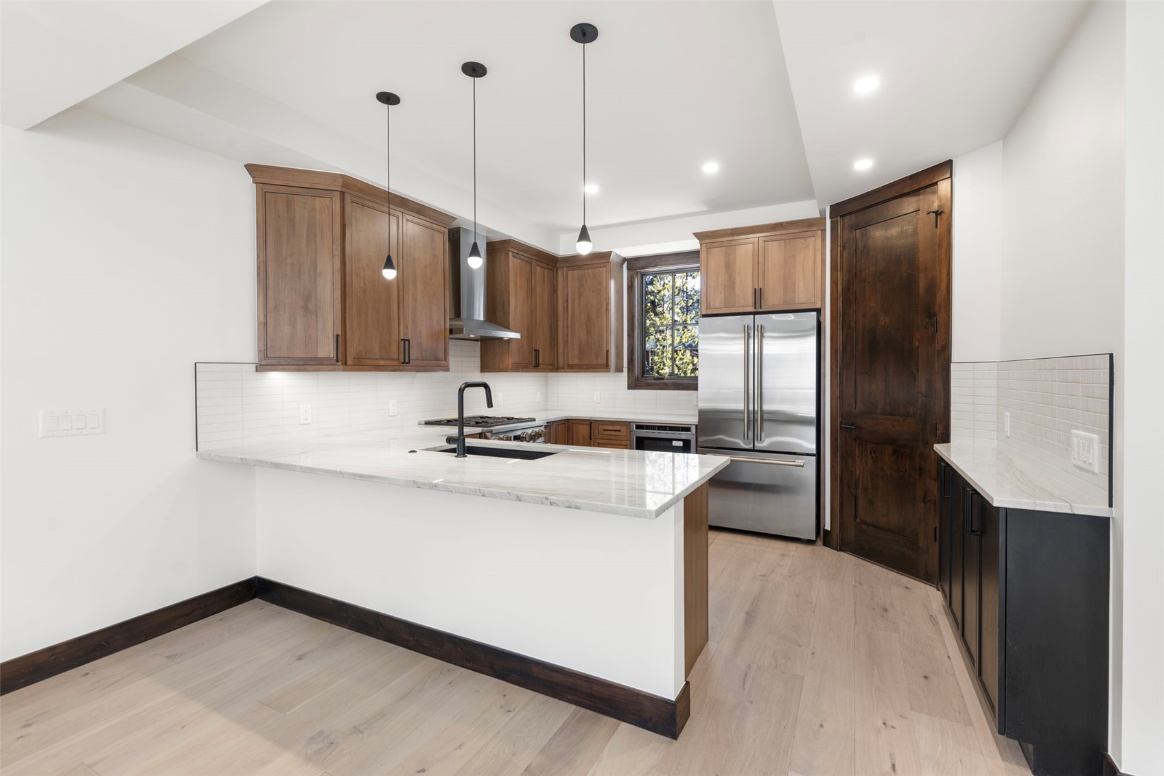 312 3rd Avenue, Unit 1 Frisco, CO 80443 - Photo 15 of 42 a kitchen with kitchen island a sink stainless steel appliances and cabinets