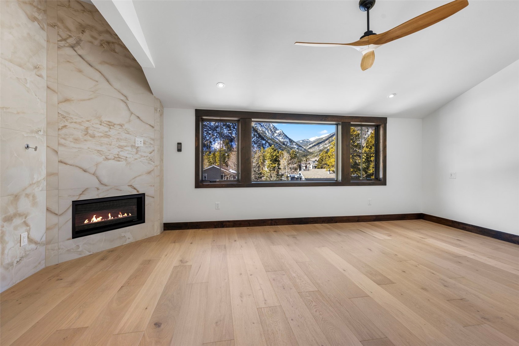 312 3rd Avenue, Unit 1 Frisco, CO 80443 - Photo 18 of 42 an empty room with windows fireplace and wooden floor