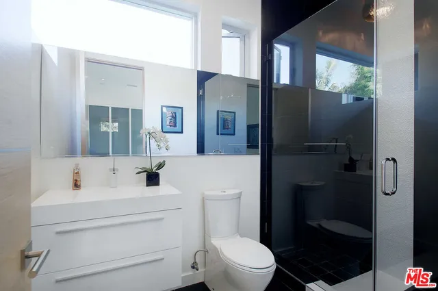 a bathroom with a toilet sink and shower