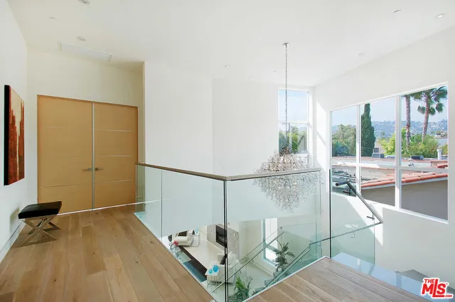a view of a room with wooden floor and windows