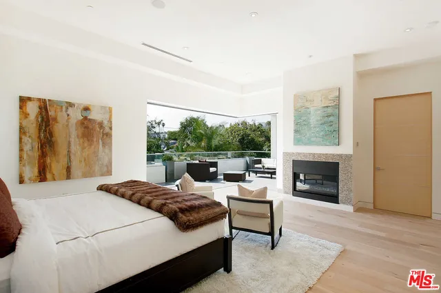 a bedroom with a bed and a fireplace