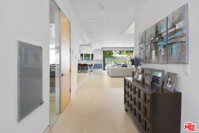 a living room with furniture and large windows