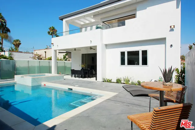 a view of a patio with couches table and chairs with potted plants