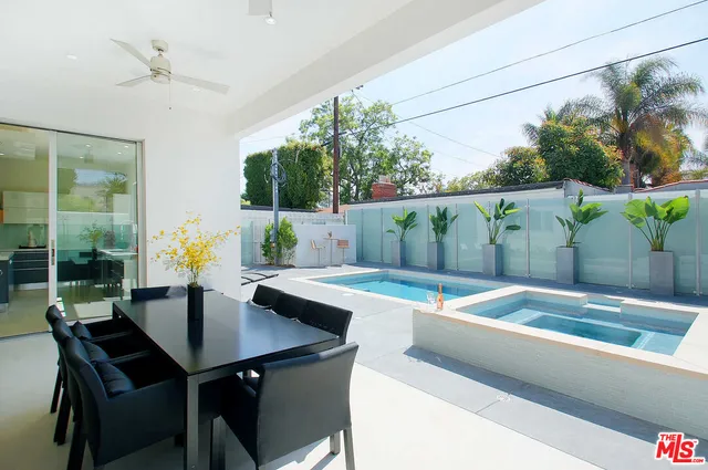 a view of a dining table and chairs in the patio