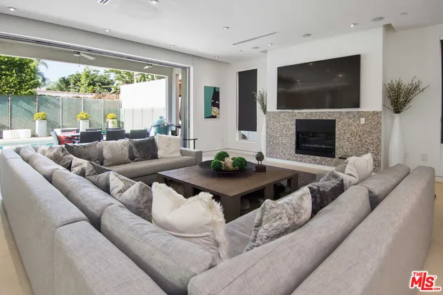 a living room with fireplace furniture and a flat screen tv