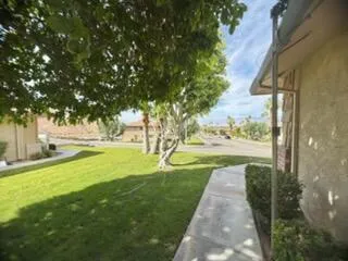 a backyard of a house with table and chairs
