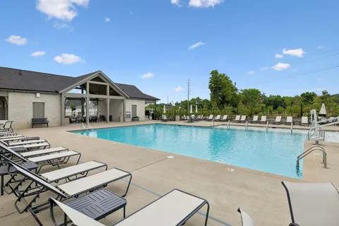 a view of a lake with couches chairs