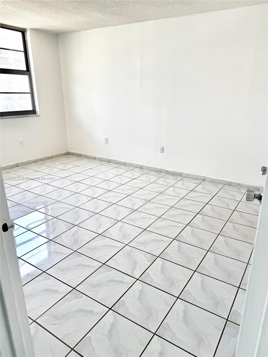 5701 Collins Avenue, Unit 1011 Miami Beach, FL 33140 - Photo 12 of 46 a view of a room and window