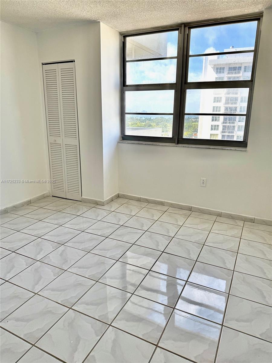 5701 Collins Avenue, Unit 1011 Miami Beach, FL 33140 - Photo 13 of 46 a view of an empty room with a window