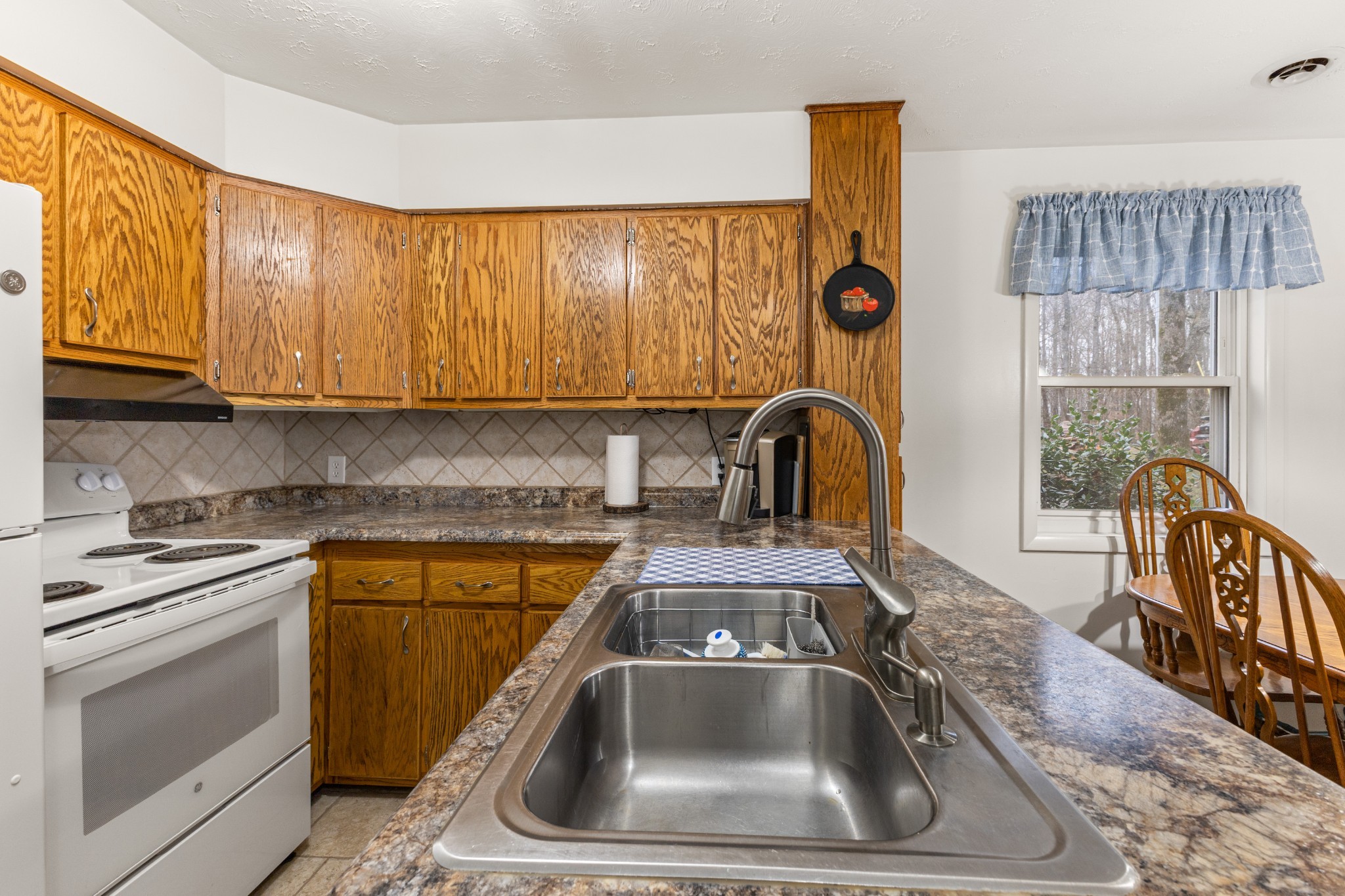 392 Feather Ridge Road Charlotte, TN 37036 - Photo 12 of 31 a kitchen with a sink and a stove top oven