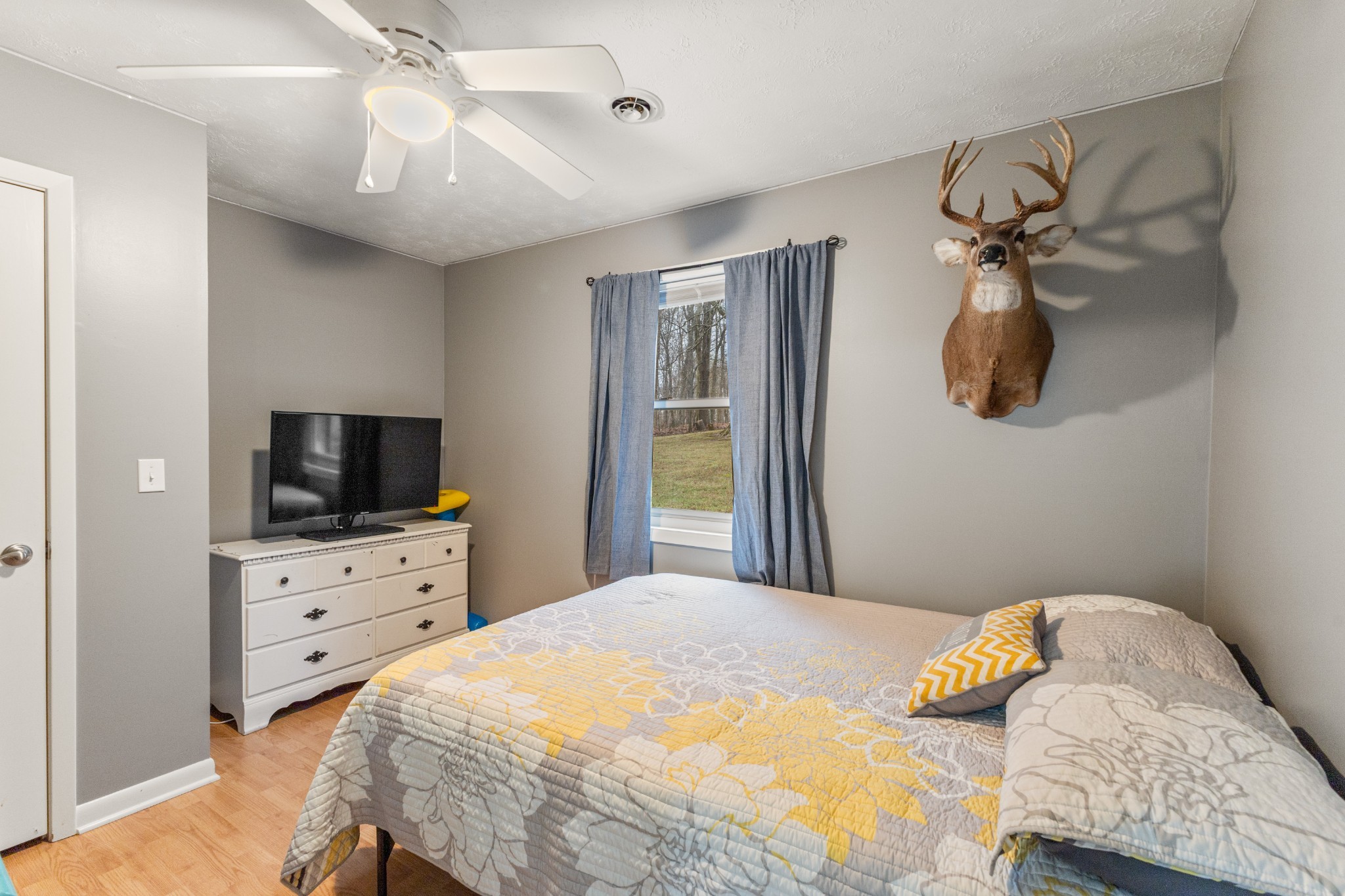 392 Feather Ridge Road Charlotte, TN 37036 - Photo 14 of 31 a bedroom with a bed and a flat screen tv