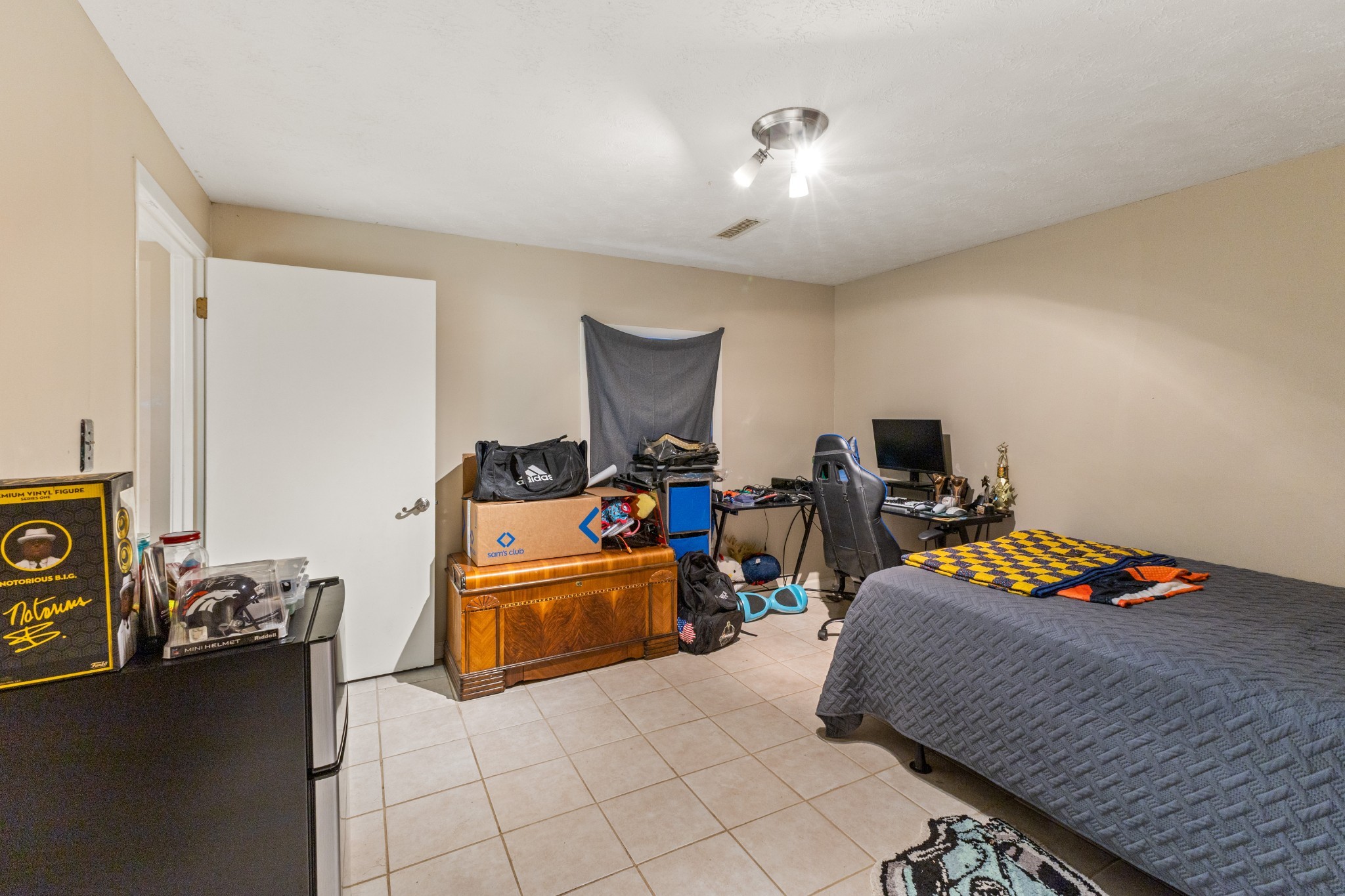 392 Feather Ridge Road Charlotte, TN 37036 - Photo 18 of 31 a bedroom with bed and a chandelier