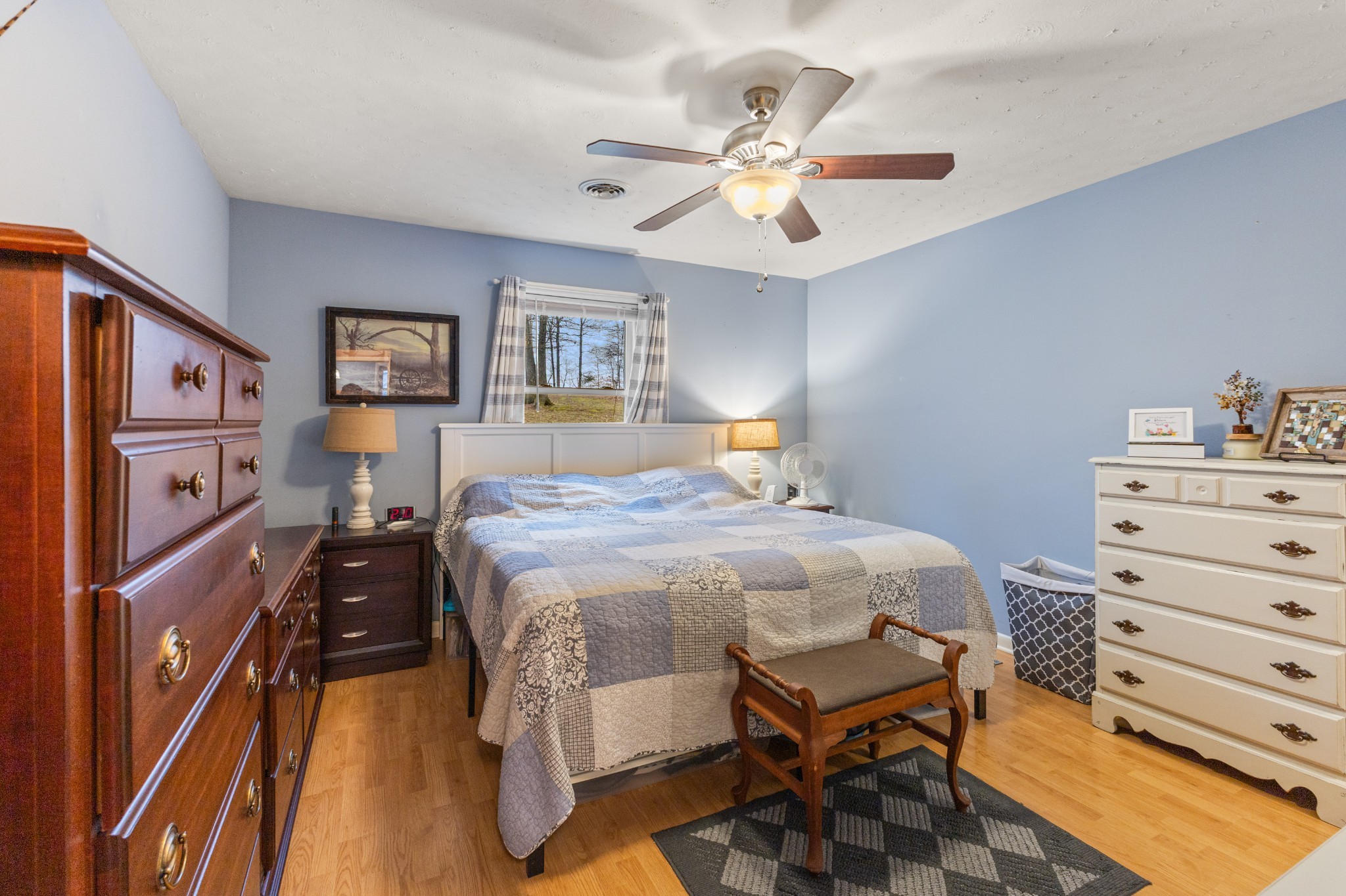 392 Feather Ridge Road Charlotte, TN 37036 - Photo 6 of 31 a bedroom with a bed and a chandelier