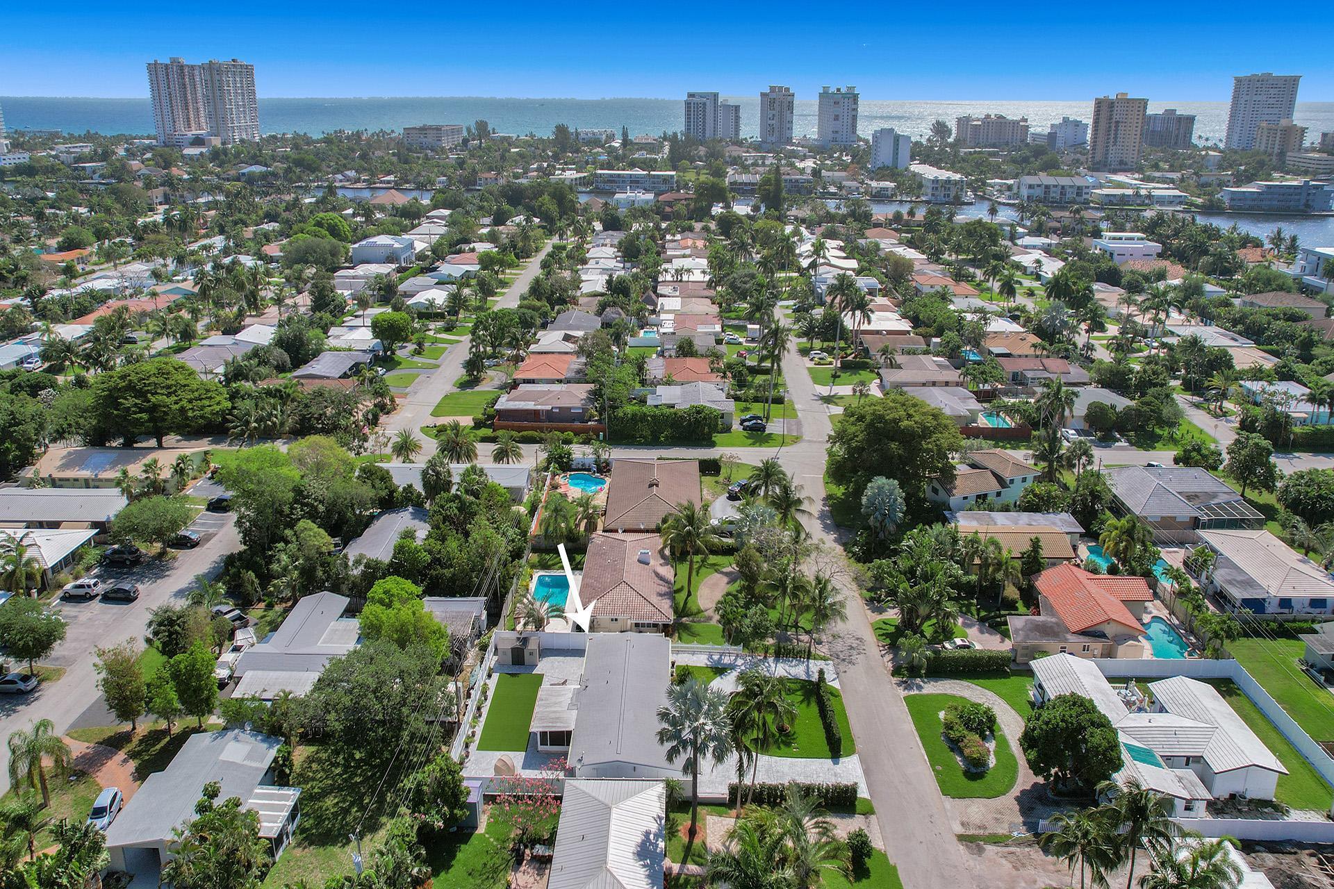 an aerial view of residential houses with city view