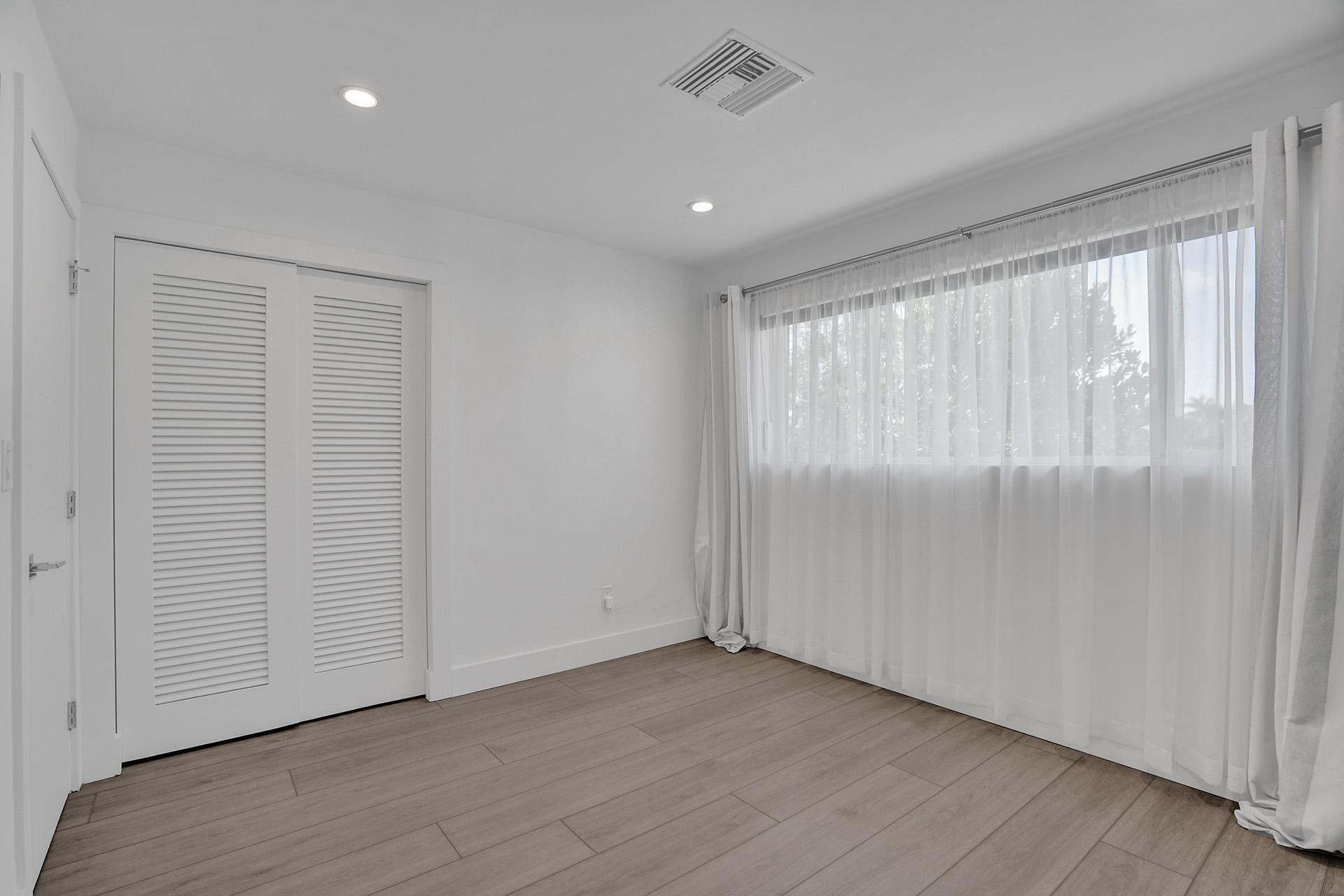 2425 Southeast 6th Street Pompano Beach, FL 33062 - Photo 16 of 18 a view of an empty room with wooden floor and a window