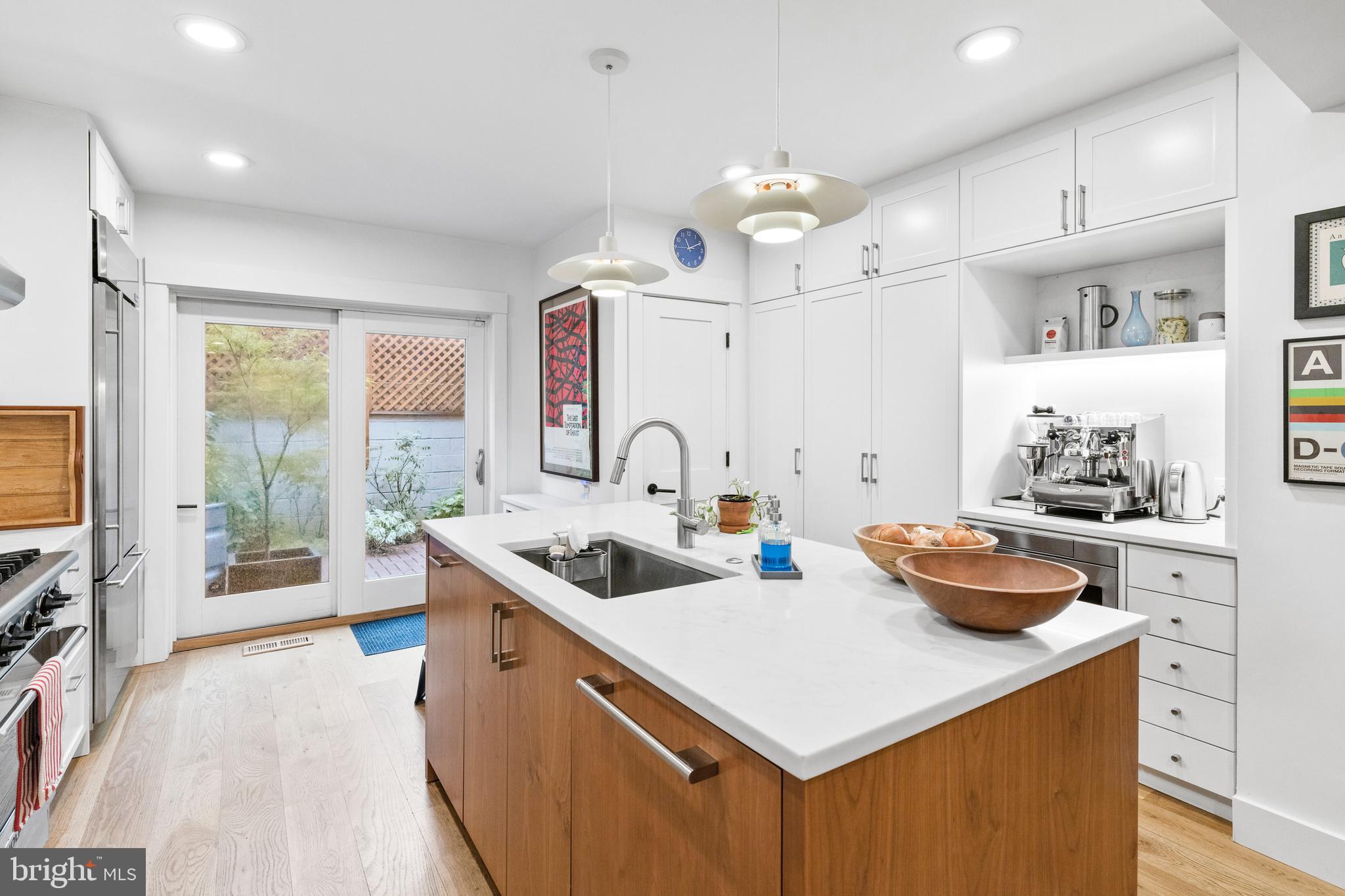 340 South Smedley Street Philadelphia, PA 19103 - Photo 11 of 38 a kitchen that has a sink a stove and a wooden floor