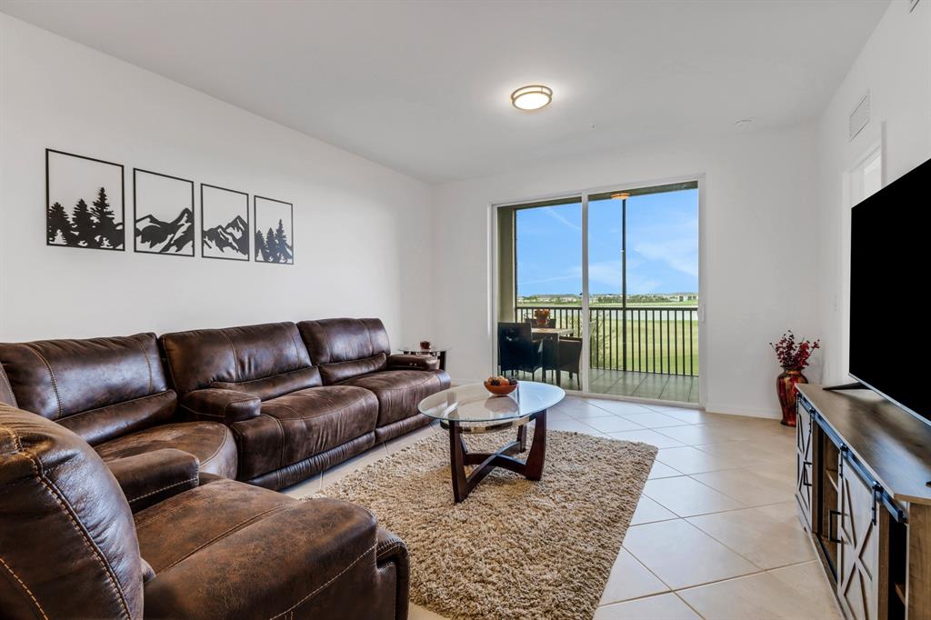 5651 Double Eagle Circle, Unit 4324 Immokalee, FL 34142 - Photo 1 of 25 a living room with furniture and a flat screen tv