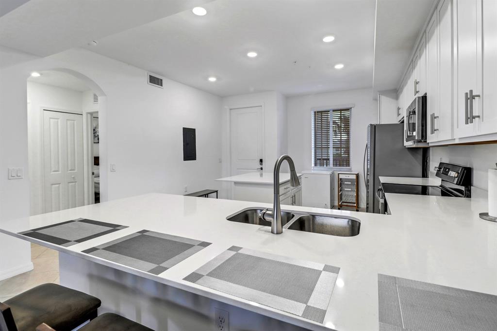 5651 Double Eagle Circle, Unit 4324 Immokalee, FL 34142 - Photo 12 of 25 a kitchen with a sink a stove and cabinets