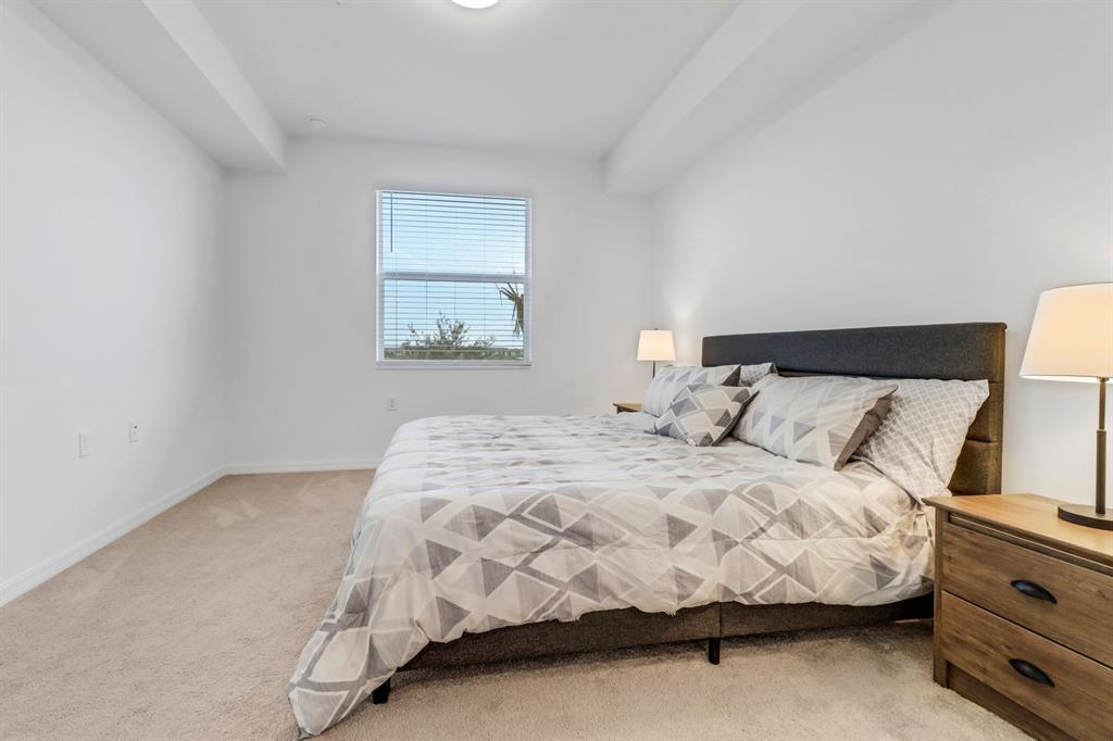 5651 Double Eagle Circle, Unit 4324 Immokalee, FL 34142 - Photo 14 of 25 a bedroom with a bed and lamp