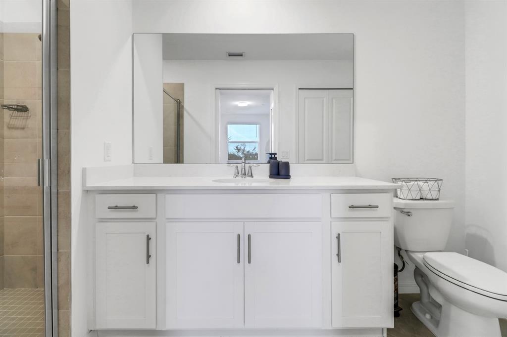 5651 Double Eagle Circle, Unit 4324 Immokalee, FL 34142 - Photo 16 of 25 a bathroom with a toilet sink and mirror
