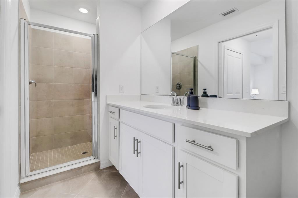 5651 Double Eagle Circle, Unit 4324 Immokalee, FL 34142 - Photo 17 of 25 a bathroom with a shower sink and mirror