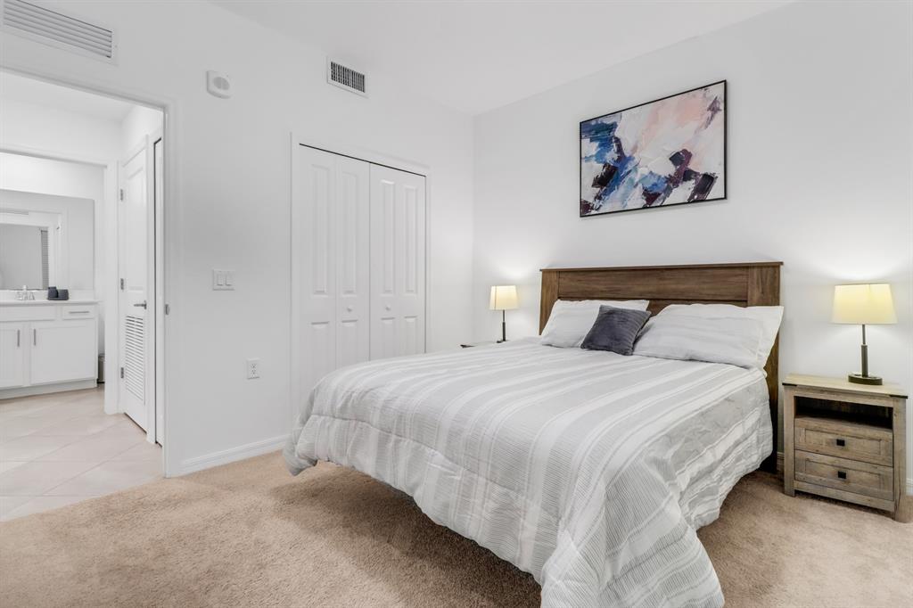 5651 Double Eagle Circle, Unit 4324 Immokalee, FL 34142 - Photo 19 of 25 a bedroom with a bed and a painting on the wall