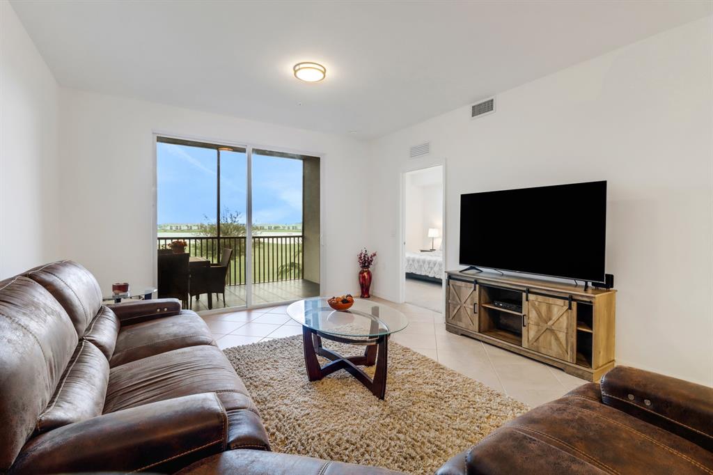 5651 Double Eagle Circle, Unit 4324 Immokalee, FL 34142 - Photo 3 of 25 a living room with furniture and a flat screen tv