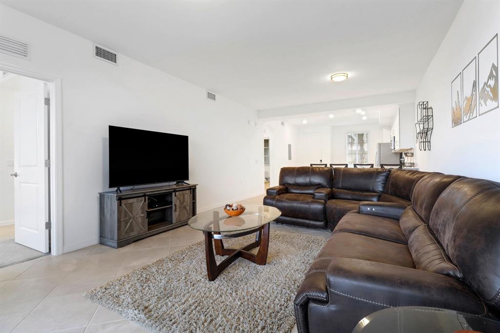 5651 Double Eagle Circle, Unit 4324 Immokalee, FL 34142 - Photo 4 of 25 a living room with furniture and a flat screen tv