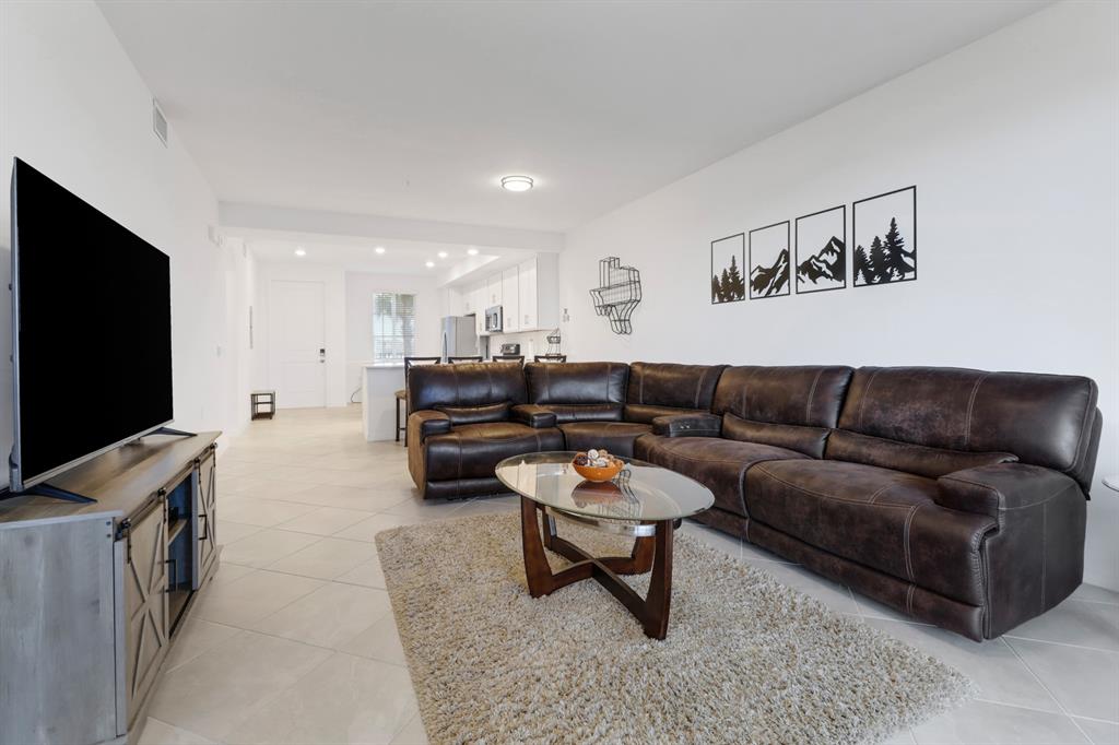 5651 Double Eagle Circle, Unit 4324 Immokalee, FL 34142 - Photo 5 of 25 a living room with furniture and a flat screen tv