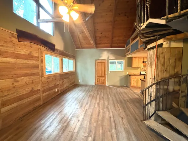 a view of a porch with wooden floor and seating space