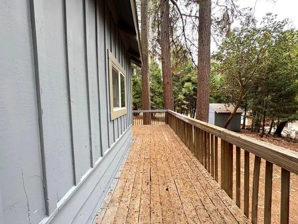 a view of a balcony with wooden floor