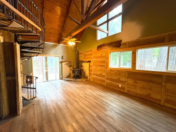 a view of a room with wooden floor and windows