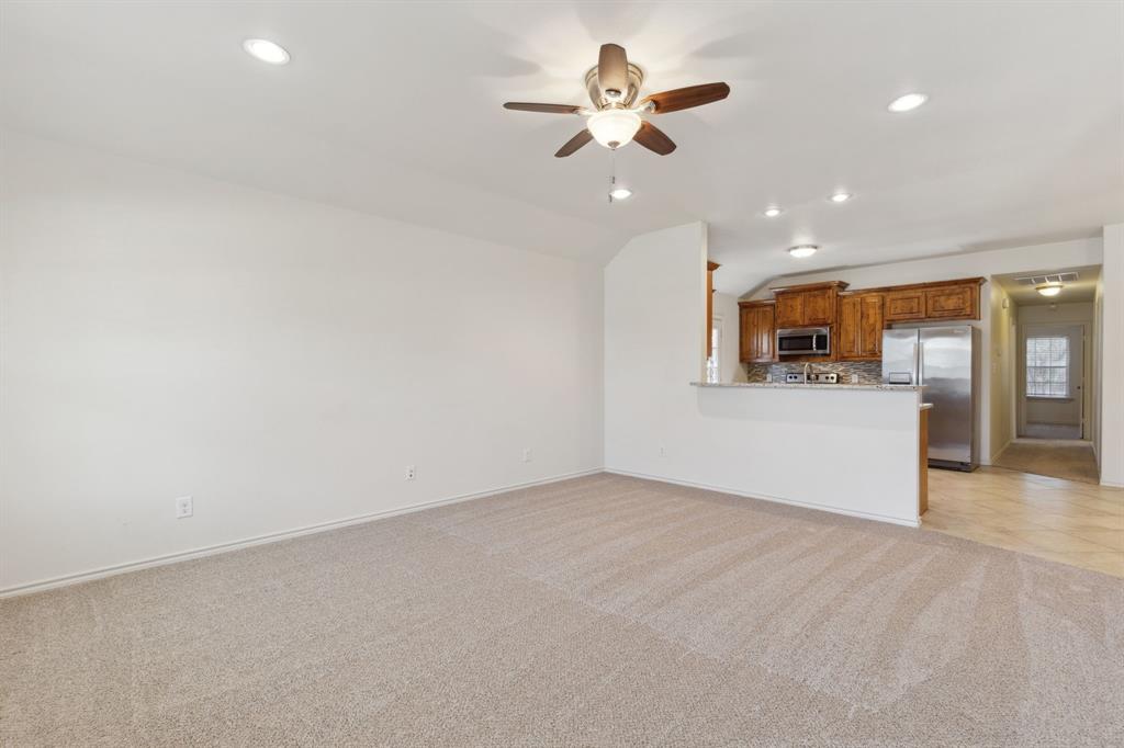 233 Firefly Drive Springtown, TX 76082 - Photo 2 of 16 Living room ceiling fan an open to kitchen