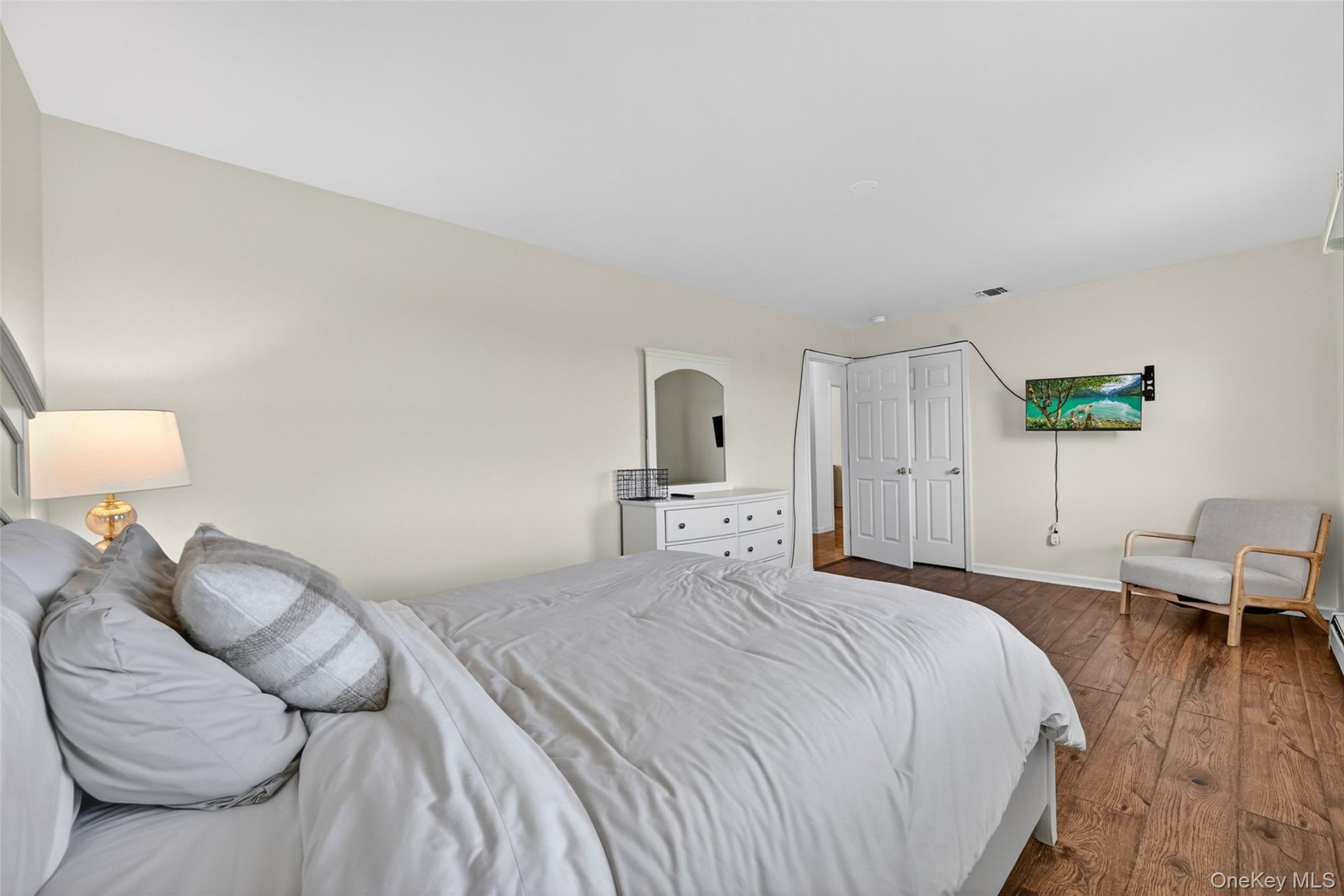 19 Bull Mine Road Chester, NY 10918 - Photo 31 of 42 Bedroom featuring wood-finish flooring, neutral wall tones, and white bi-fold closet doors