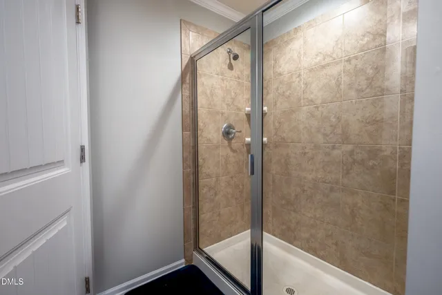 a bathroom with a glass shower door